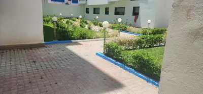 a courtyard with a row of bushes and street lights at Bel appart les belles rives bouznika Couples non mariés non acceptés in Bouznika