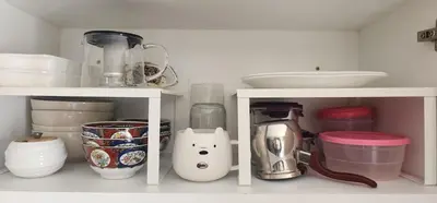 a kitchen with white shelves with food and appliances at Bel appart les belles rives bouznika Couples non mariés non acceptés in Bouznika