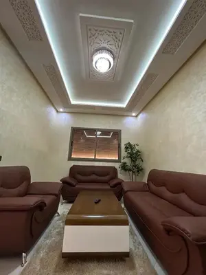 a living room with couches and a table at Skhirat apartment in Skhirat