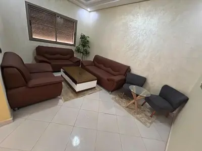 a living room with two couches and a table at Skhirat apartment in Skhirat