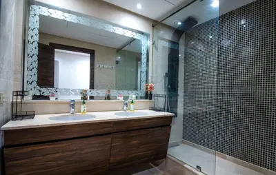 a bathroom with two sinks and a shower at Forest View -3 Bedroom Apartment - Near Airport in Nouaseur