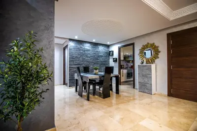 a dining room with a table and chairs at Forest View -3 Bedroom Apartment - Near Airport in Nouaseur