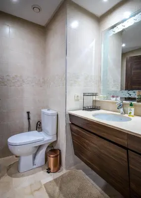 a bathroom with a toilet and a sink at Forest View -3 Bedroom Apartment - Near Airport in Nouaseur