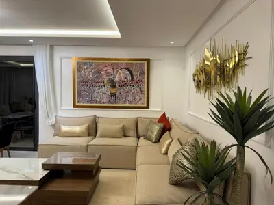 a living room with a couch and a table at Furnished and bright apartment in Rabat