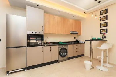a kitchen with a refrigerator and a washing machine at New and bright stylish studio in Casablanca
