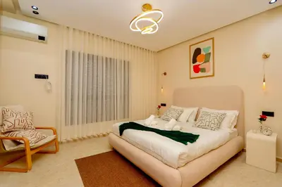 a bedroom with a large bed and a chair at New and bright stylish studio in Casablanca