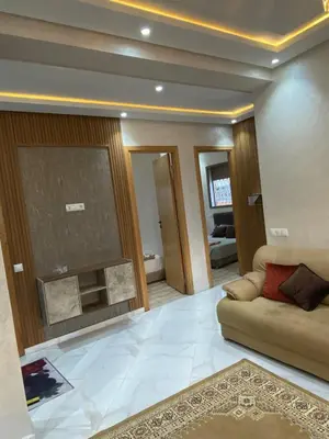 a living room with a couch and a fireplace at Sunny Cozy House Close to the Beach in Bouznika