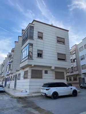 a white car parked in front of a building at Sunny Cozy House Close to the Beach in Bouznika
