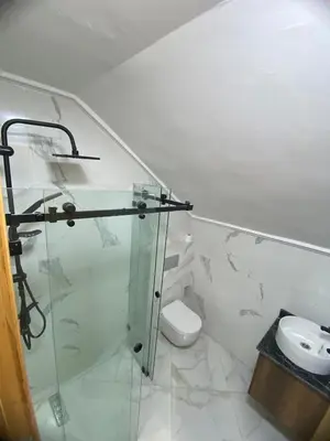 a bathroom with a glass shower and a toilet at Sunny Cozy House Close to the Beach in Bouznika