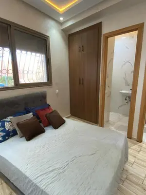 a bedroom with a large bed in a room at Sunny Cozy House Close to the Beach in Bouznika