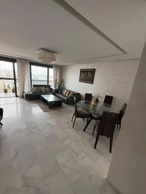 a living room with a table and a couch at Luxurious Apartment in Hay Riad in Rabat
