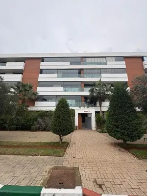 a large office building with a driveway in front of it at Luxurious Apartment in Hay Riad in Rabat