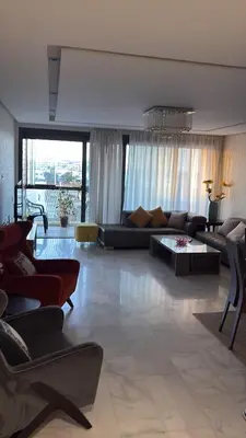 a living room with a couch and a table at Luxurious Apartment in Hay Riad in Rabat