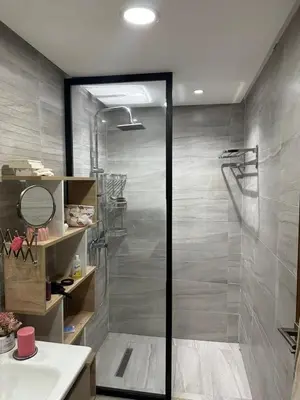 a shower with a glass door in a bathroom at Appartement meublé à louer à dar bouazza in Tamaris