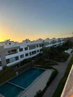 a view of a building with a swimming pool at Appartement meublé à louer à dar bouazza in Tamaris