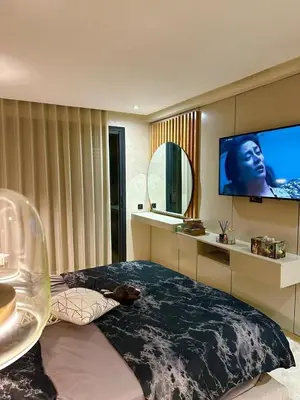 a bedroom with a large bed and a flat screen tv at Appartement meublé à louer à dar bouazza in Tamaris