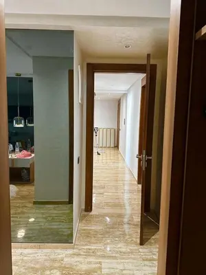 an empty room with a hallway leading to a kitchen at Appartement meublé à louer à dar bouazza in Tamaris