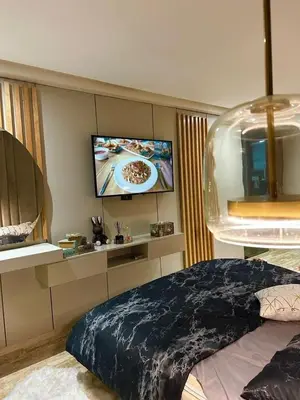 a bedroom with a bed and a flat screen tv at luxury furnished apartment for rent in Tamaris