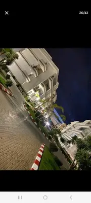 a large white building with a street in front of it at Apparemment in Mansouria