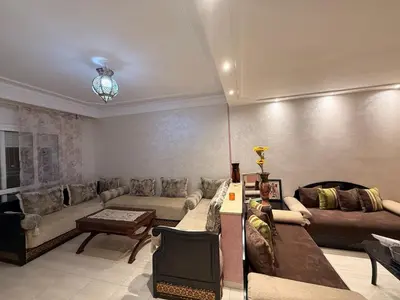 a large living room with couches and a table at Agdal Central Spacious 2BR with Terrace in Rabat