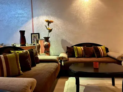 a living room with two couches and a table at Agdal Central Spacious 2BR with Terrace in Rabat