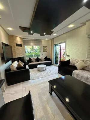 a large living room with couches and a coffee table at Duplex océan harhoura avec une grande terrasse in Temara