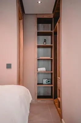 a bedroom with a bed and a book shelf at AnfaSuites - Résidence Pashmina - Maarif - Parking in Maarif