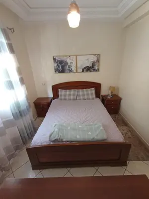 a bedroom with a large bed in a room at Summer & family apartments, Cheer on your team CAN in Mohammedia