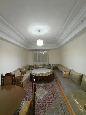 a living room with a couch and a table at Summer & family apartments, Cheer on your team CAN in Mohammedia