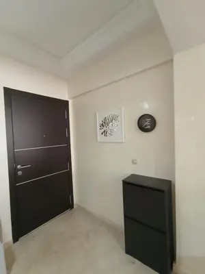 a room with a black door and a clock on the wall at Summer & family apartments, Cheer on your team CAN in Mohammedia
