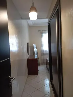 a hallway with a bathroom with a mirror and a door at Summer & family apartments, Cheer on your team CAN in Mohammedia