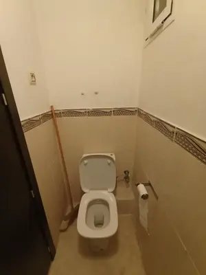 a small bathroom with a toilet and a roll of toilet paper at Summer & family apartments, Cheer on your team CAN in Mohammedia