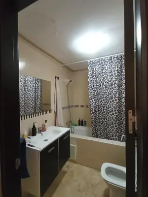 a bathroom with a sink and a tub and a toilet at Summer & family apartments, Cheer on your team CAN in Mohammedia