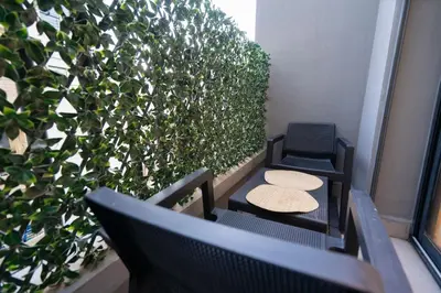 a couple of chairs and a table on a balcony at Luxury Studio Corniche near H2 Area in Casablanca