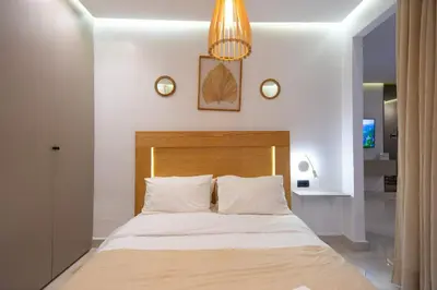 a bedroom with a bed and a chandelier at Luxury Studio Corniche near H2 Area in Casablanca