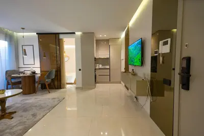a large living room with a television and a kitchen at Luxury Studio Corniche near H2 Area in Casablanca