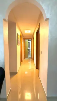 an empty hallway with an archway in a building at Chic 2-bedroom apartment, pool and beach 5 min away in Mohammedia