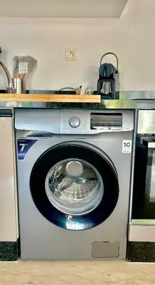 a washing machine with a kettle on top of it at Zen Terrace Design Studio in Zenata, WiFi & Pool in Aïn Harrouda