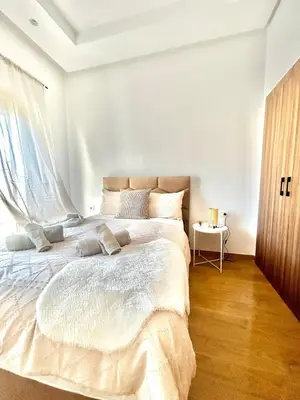 a bedroom with a large white bed with a window at Zen Terrace Design Studio in Zenata, WiFi & Pool in Aïn Harrouda