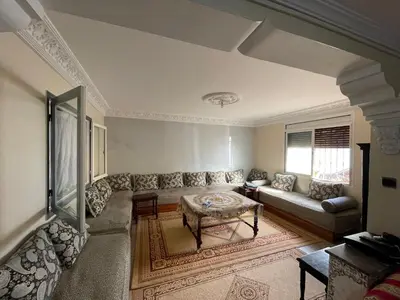 a living room with a couch and a table at Appartement a louer par jours in Temara
