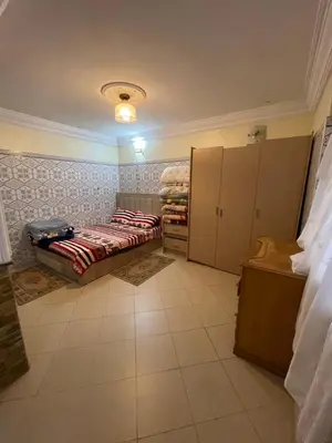 a bedroom with a bed and cabinets in a room at Appartement a louer par jours in Temara