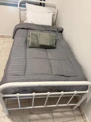 a bed with a metal frame in a bedroom at Spacious apartment in Agdal, close to everything in Rabat
