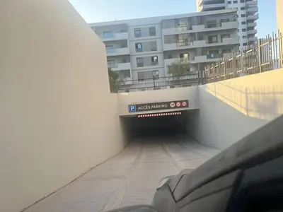a tunnel with a sign on the side of a building at Studio calme Vue piscine À deux pas de la mer in Aïn Sebaa