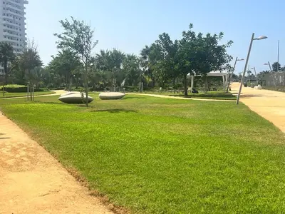 a park with two objects in the grass at Studio calme Vue piscine À deux pas de la mer in Aïn Sebaa