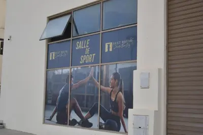 a window with a picture of a woman and a man at Studio calme Vue piscine À deux pas de la mer in Aïn Sebaa