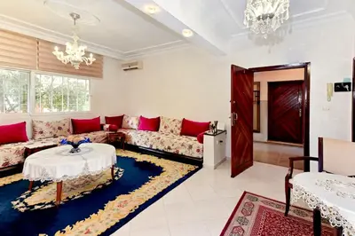 a living room with a couch and a table at Appartement chic de 2 chambres au coeur de casablanca in Casablanca