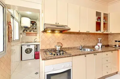 a kitchen with a sink and a stove top oven at Appartement chic de 2 chambres au coeur de casablanca in Casablanca