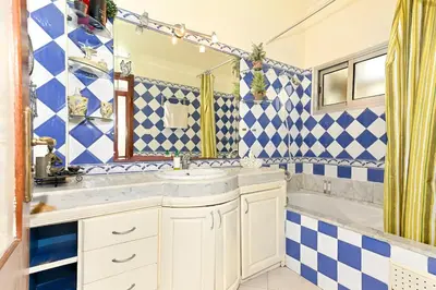 a bathroom with blue and white checkered tiles at Appartement chic de 2 chambres au coeur de casablanca in Casablanca