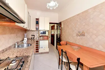 a kitchen with a wooden table and a dining room at Appartement chic de 2 chambres au coeur de casablanca in Casablanca