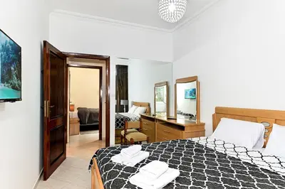 a bedroom with a bed and a desk with a mirror at Appartement chic de 2 chambres au coeur de casablanca in Casablanca